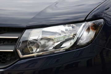 Car'sCar exterior detail.shiny headlight on a black  car exterior detail, headlight on a  new car