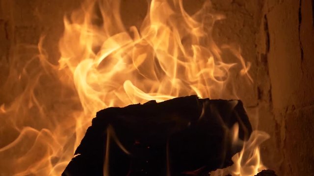Firewood burning in a tile stove 180 fps slow motion - tilt up