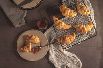 Baked croissants with strawberry jam