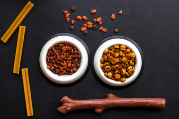 Animal food in bowl on black background top view space for text