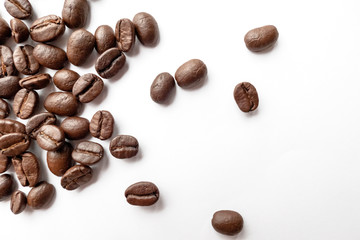 Roasted coffee beans isolated on white background. Close-up.