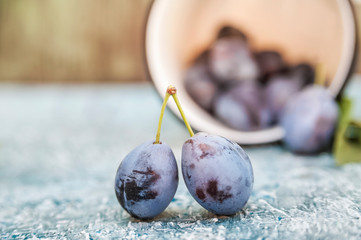 Natural texture of homemade fruit. Ripe juicy plums on a blue background close up and save space