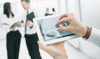 close up. digital tablet in the hands of a businessman.