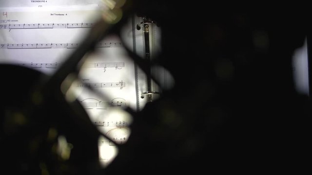 Trombone players music sheet in slow motion