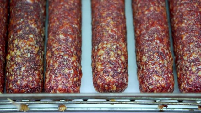 Smoked sausage is on the shelf in the store. Choosing and buying food in the supermarket