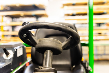 Forklift drivers wheel and seat in factory