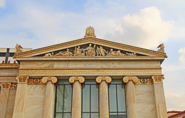 Obraz premium Right wing building, of the National Academy of Arts in Athens, Greece with ornate details and Greek statue carvings with blue sky copy space.