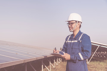 engineer or electrician inspect and checking solar equipment ;smart technology for operation of solar power plant by smart operator