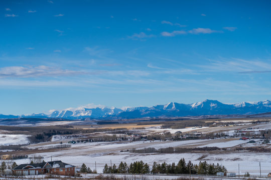 fields landscape with mountains on the horizon in winter