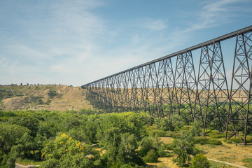 railway bridge crossing a river to the horizon