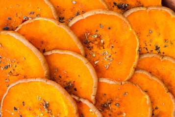 Round pumpkin slices (pieces) baked, grilled in oven with spices and herbs: thyme, oregano, garlic. Vegan, vegetarian healthy food.