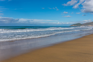 Fototapeta na wymiar Waves Washing up on the Beach on the Southern Italian Mediterranean Coast on a Sunny Day