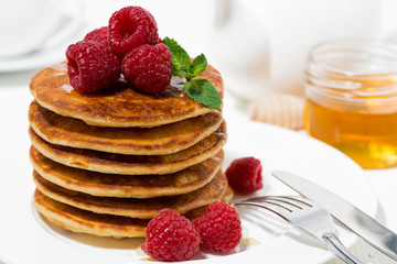 stack of pancakes with raspberries for breakfast, closeup