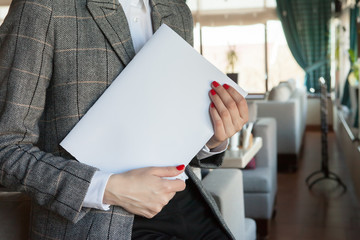 the girl holds in hand the magazine model the A4 format