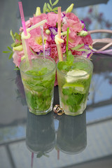 Wedding rings. Mojito and wedding rings. Wedding rings on cocktail tubes. Close-up