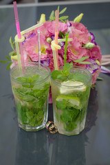 Wedding rings. Mojito and wedding rings. Wedding rings on cocktail tubes. Close-up