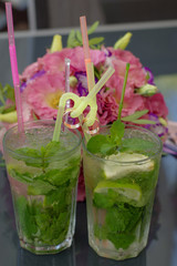 Wedding rings. Mojito and wedding rings. Wedding rings on cocktail tubes. Close-up