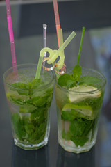 Wedding rings. Mojito and wedding rings. Wedding rings on cocktail tubes. Close-up