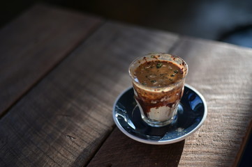 Coffee fusion cream milk and toping green tea with a morning light on wood table.