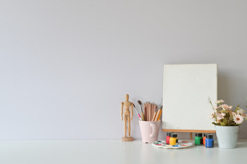 Obraz premium Office creative table with supplies and white wall.