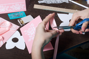 Making greeting cards from paper, cardboard and tape. Female artisan working with tape.