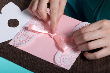 Obraz premium Making greeting cards from paper, cardboard and tape. Female artisan working with tape.