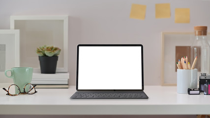 Stylish workplace desk vintage camera, blank screen tablet and gadget