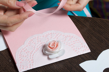 Making greeting cards from paper, cardboard and tape. Woman artisan at work.