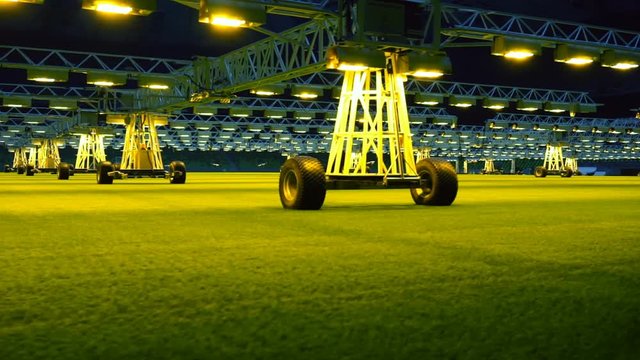 Mobile grow lighting system in sports stadium at night.