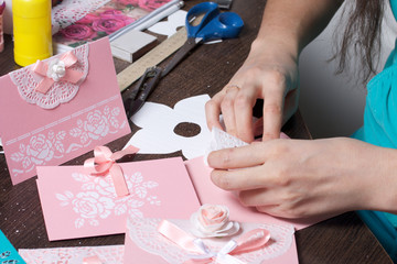 Making greeting cards from paper, cardboard and tape. Woman artisan at work.