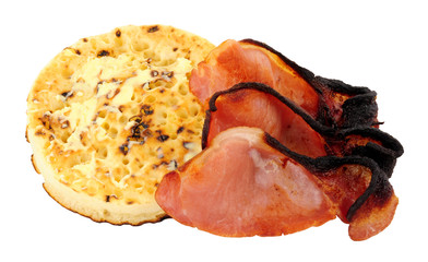 Smoked back bacon rashers on a large English crumpet isolated on a white background