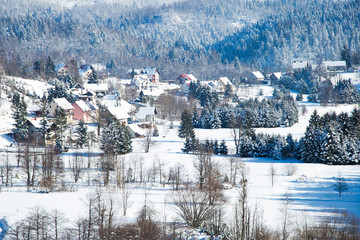     Croatian countryside landscape in winter, panorama of town of Lokve under snow in Gorski kotar, mountains in background 
