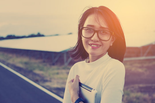 women engineer working on checking and maintenance equipment at green energy solar power plant: feeling to goal of great performance energy