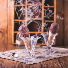 chocolate ice cream in cone on dark background with blank space
