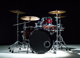 Professional drum set on stage on the black background  - obrazy, fototapety, plakaty