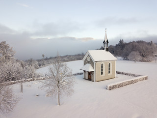 Winter Switzerland fairytale chapel on hill 