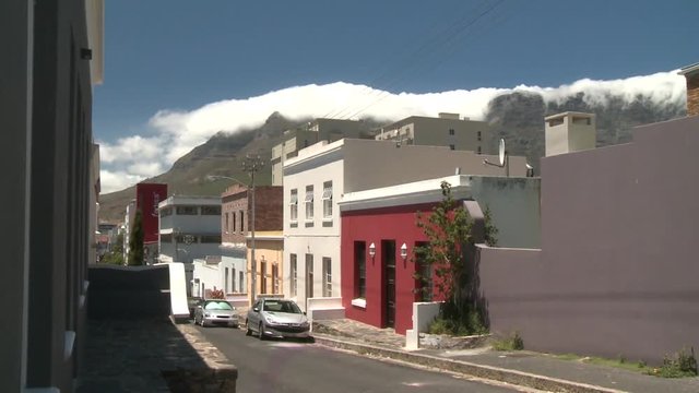 A row of Colourful houses with Clouds coming over Table Mountain in the background, Cape Town, South Africa 