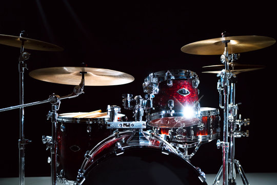 Professional drum set on stage on the black background 