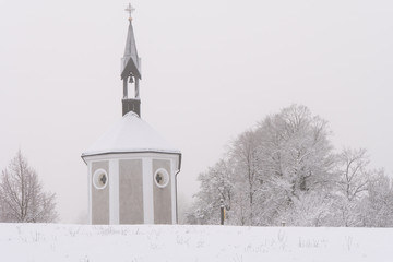 Winter Switzerland fairytale chapel on hill 