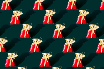 Rad gifted bag with yellow golden ribbon at the black background in the dark