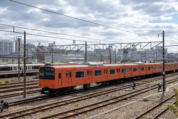 Fototapeta premium Vintage locomotive orange train in station