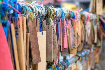 Plate wood hanging colorful thread on rail of traditional