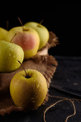 Ripe appetizing apples with burlap. Cinnamon, apples, burlap, table, knife. Fruits.