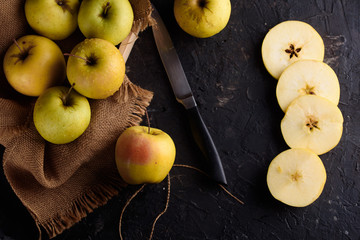 Ripe appetizing apples with burlap. Cinnamon, apples, burlap, table, knife. Fruits.
