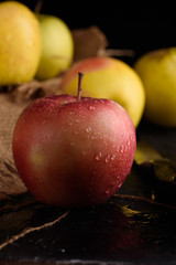 Ripe appetizing apples with burlap. Cinnamon, apples, burlap, table, knife. Fruits.