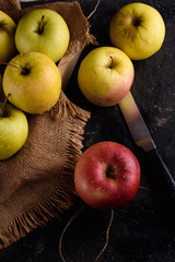 Ripe appetizing apples with burlap. Cinnamon, apples, burlap, table, knife. Fruits.