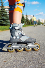 Roller skate legs close up in skatepark.Roller skates is extreme sport.Back view.