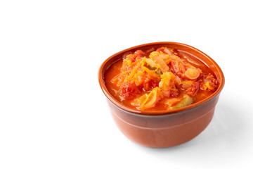 Homemade pickled salad of tomato, pepper, onion and carrot isolated on white background.