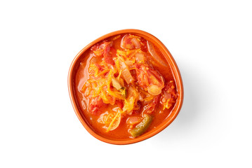 Homemade pickled salad of tomato, pepper, onion and carrot isolated on white background.