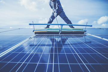 engineers operating and check generating power of solar power plant on solar rooftop; technical...